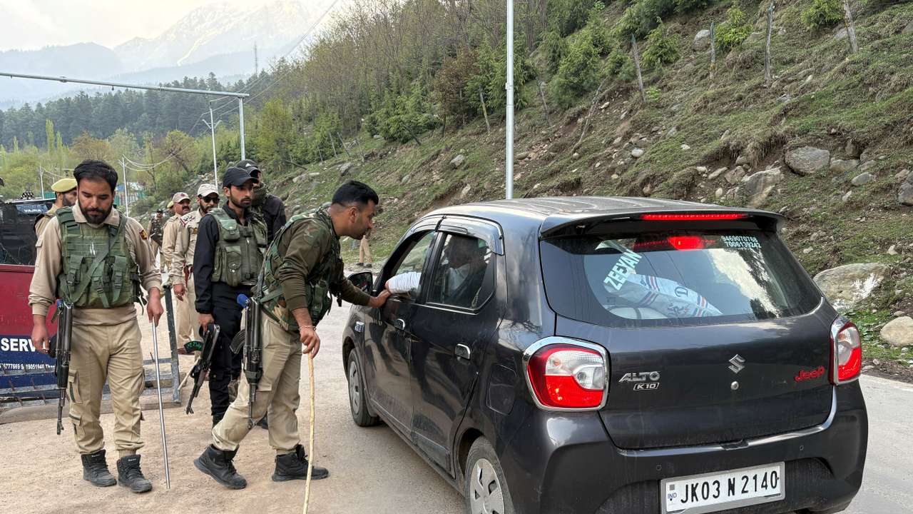 Indian police officers stop a vehicle at a check point following a suspected militant attack, near Pahalgam in south Kashmir's Anantnag district