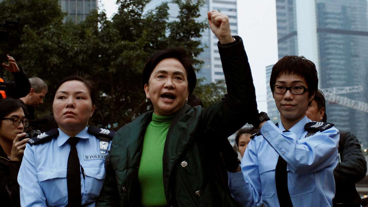 FILE PHOTO: Pro-democracy lawmaker Emily Lau chants slogans as she is taken away by the police outside the government headquarters in Hong Kong