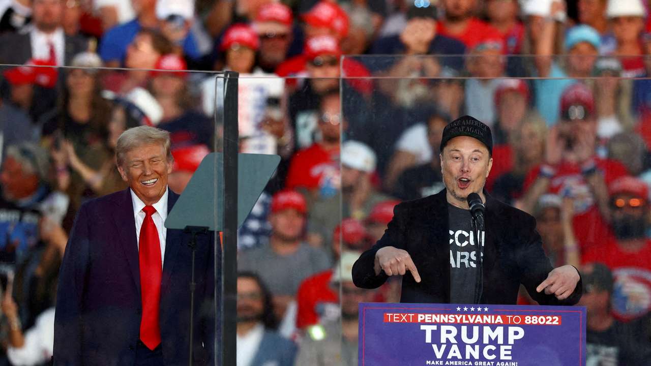 FILE PHOTO: Tesla CEO and X owner Elon Musk speaks as Donald Trump reacts during a rally in Butler