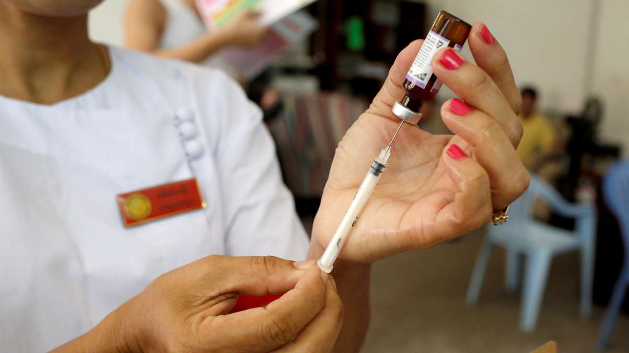 A nurse prepares a measles-rubella vaccine in Yangon