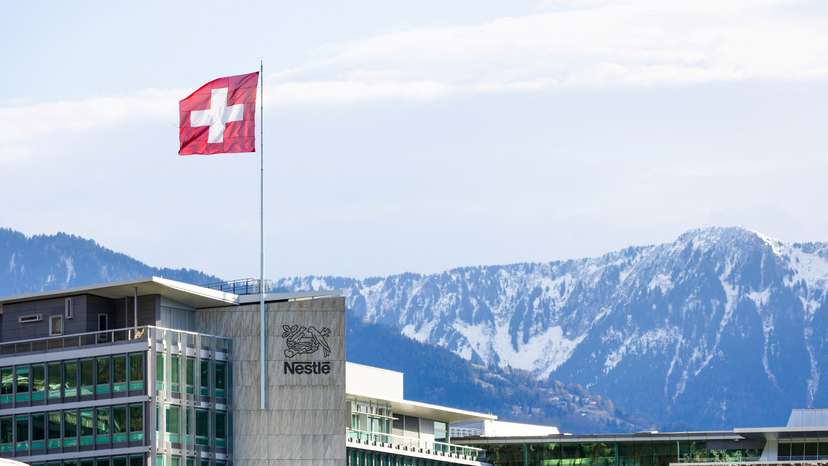 FILE PHOTO: A Swiss flag flutters on the headquarters of Nestle in Vevey