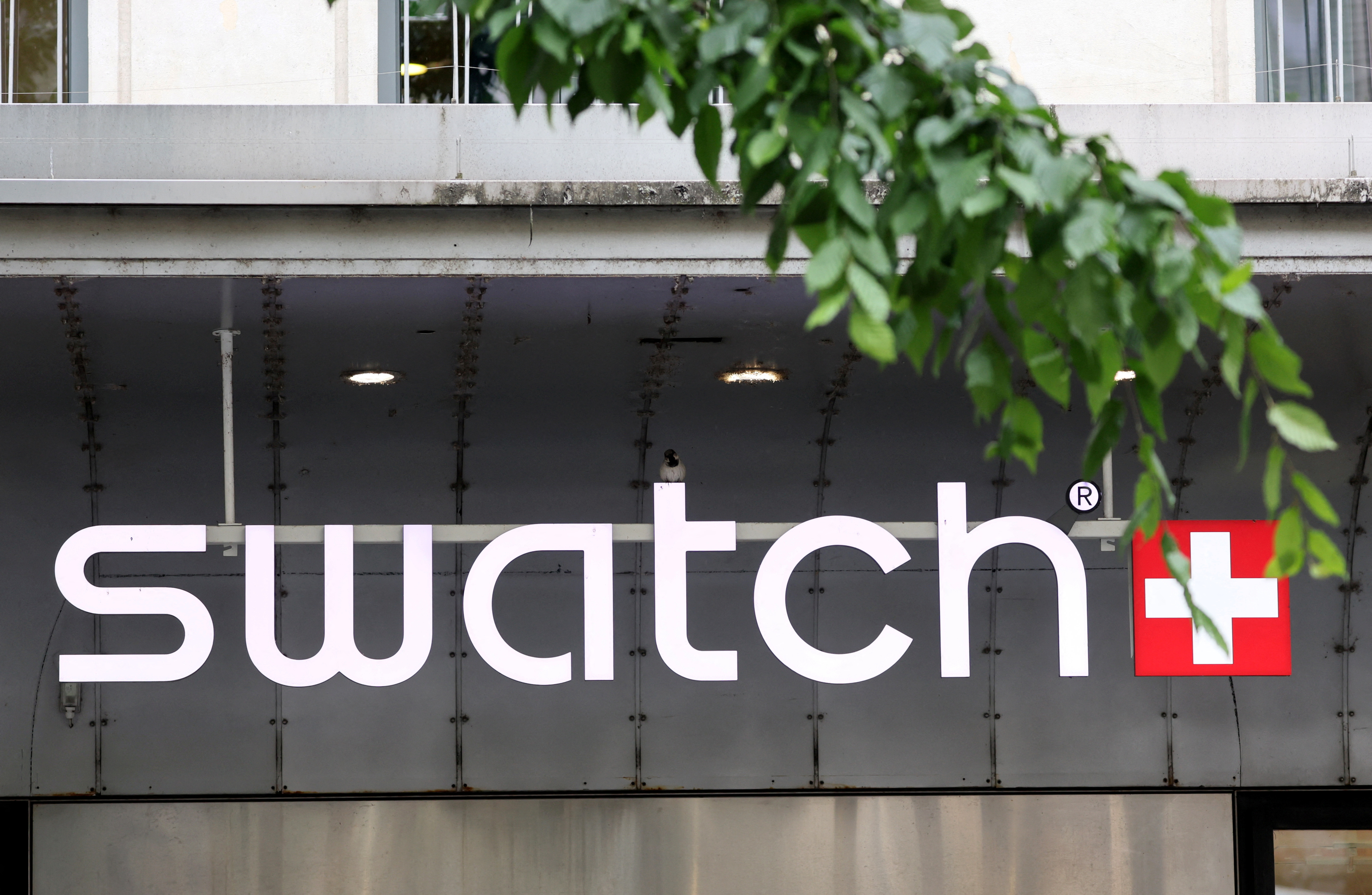 FILE PHOTO: A logo of Swiss watch maker Swatch Group is pictured on a store in Geneva