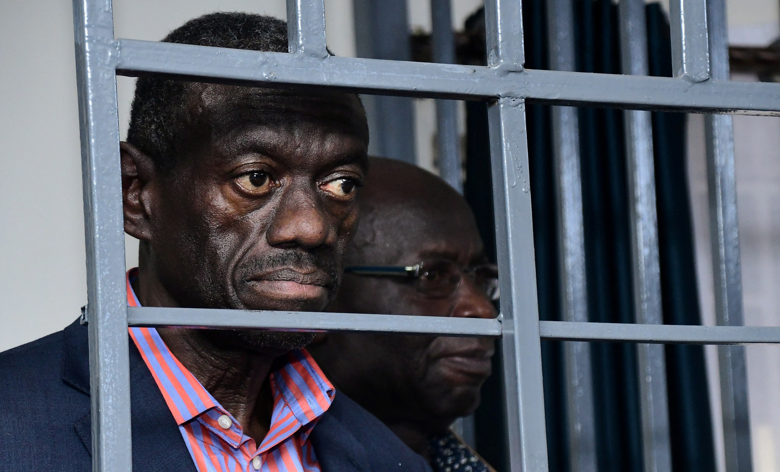 Ugandan four-time presidential aspirant Kizza Besigye stands in steel dock at Uganda Military General Court Martial in Kampala