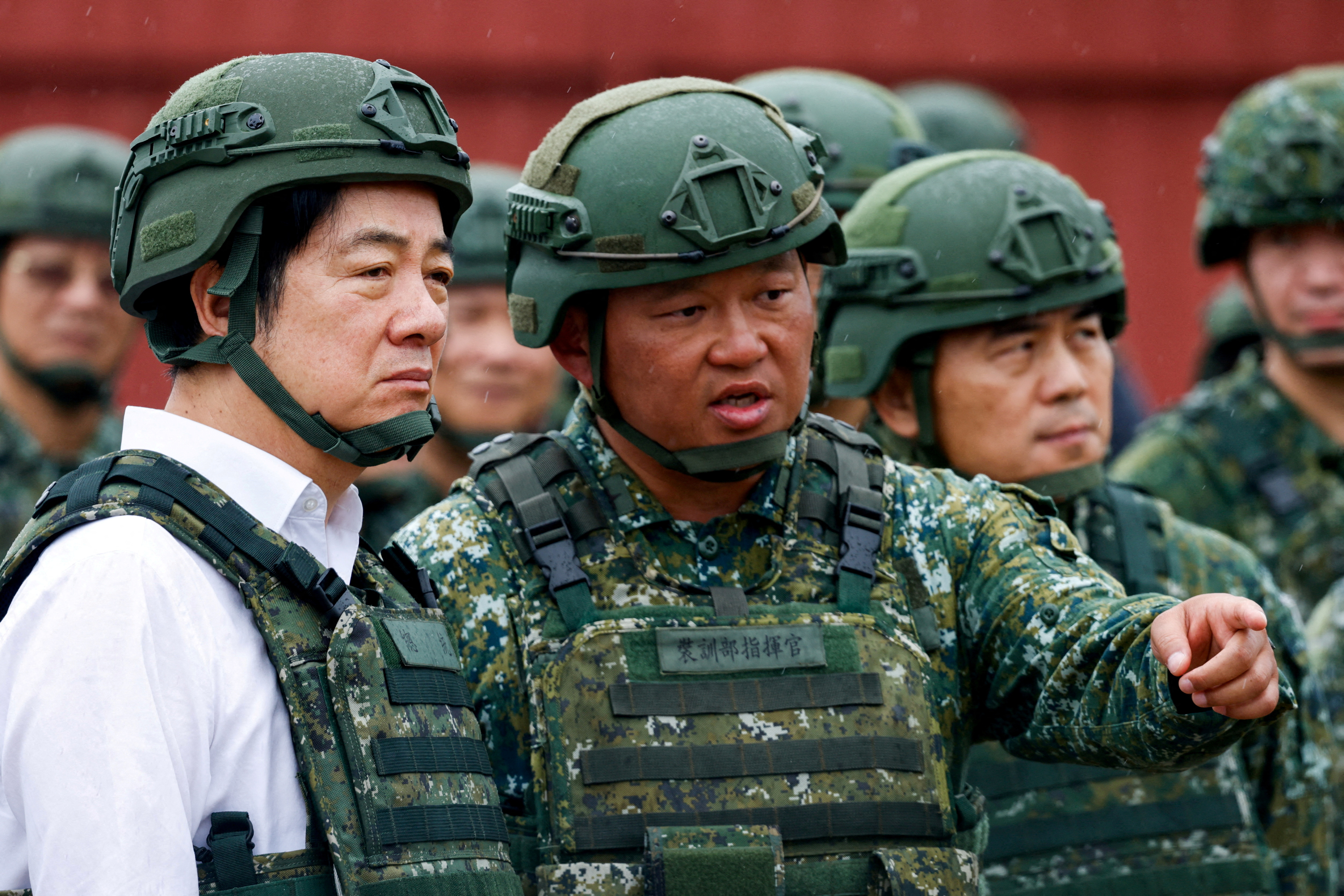 FILE PHOTO: A soldier speaks to Taiwan's President Lai Ching-te in Hsinchu