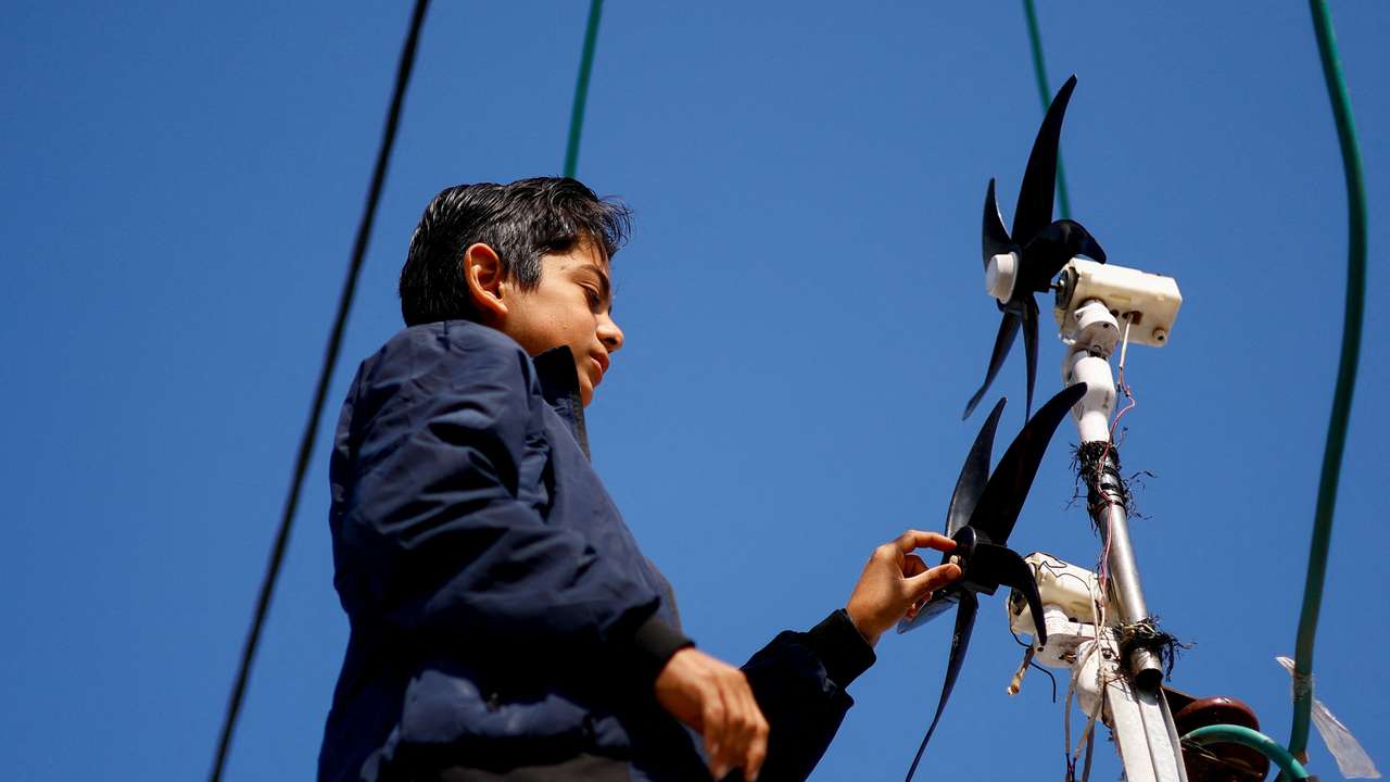Displaced 'Gaza Newton' lights up his tent with wind energy amid power cut