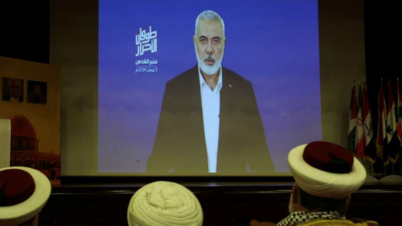 Hamas chief Ismail Haniyeh speaks in a pre-recorded message shown on a screen during an event ahead of al-Quds, in Beirut