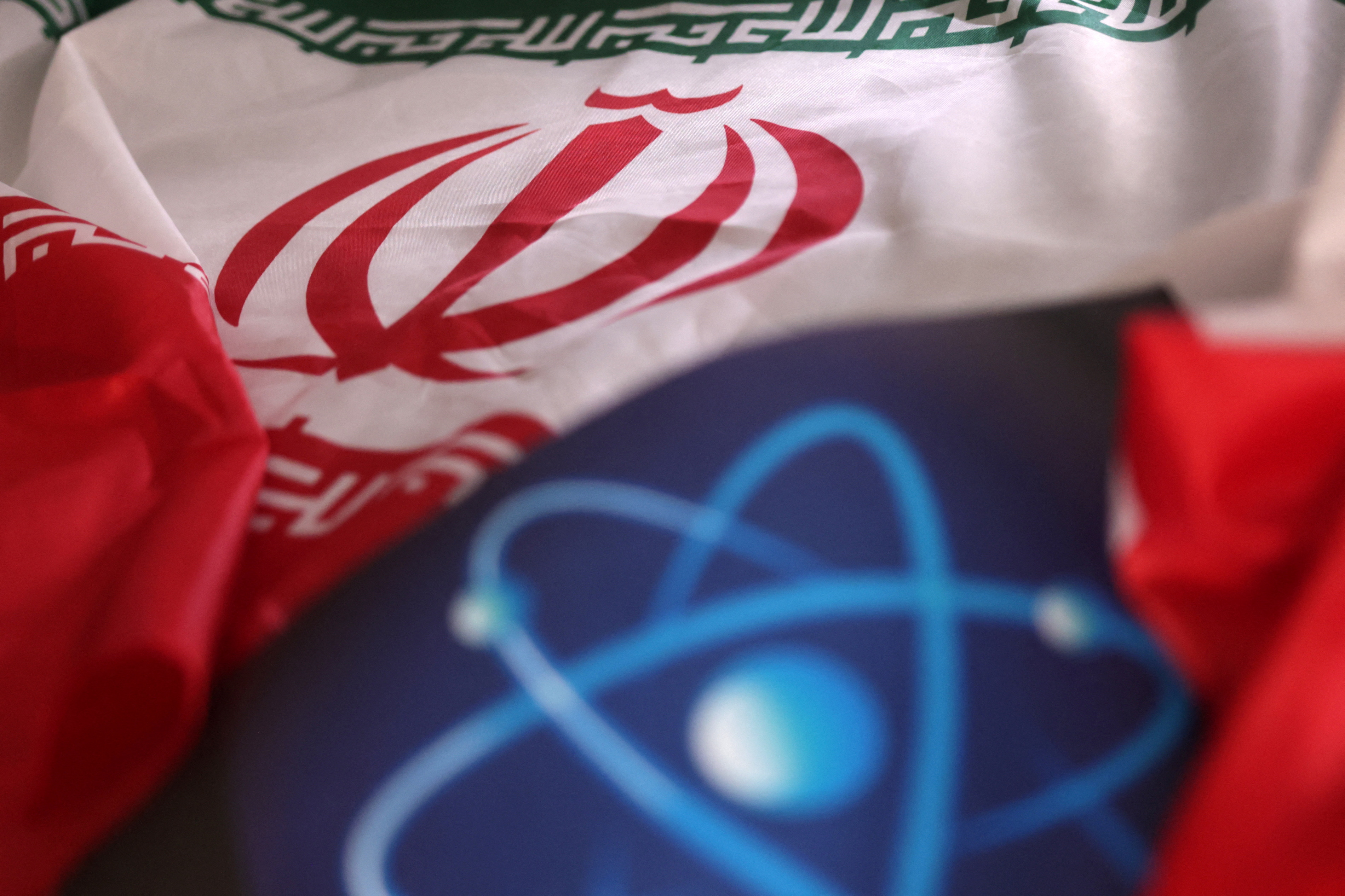 Illustration shows atomic symbol and Iranian flag