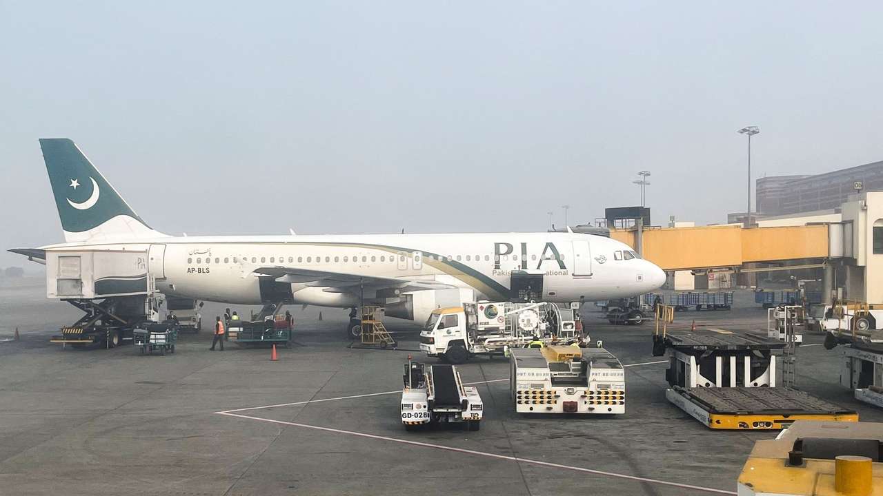 View of a Pakistan International Airlines passengers plane, taken through a glass panel, at the Allama Iqbal International Airpor in Lahore
