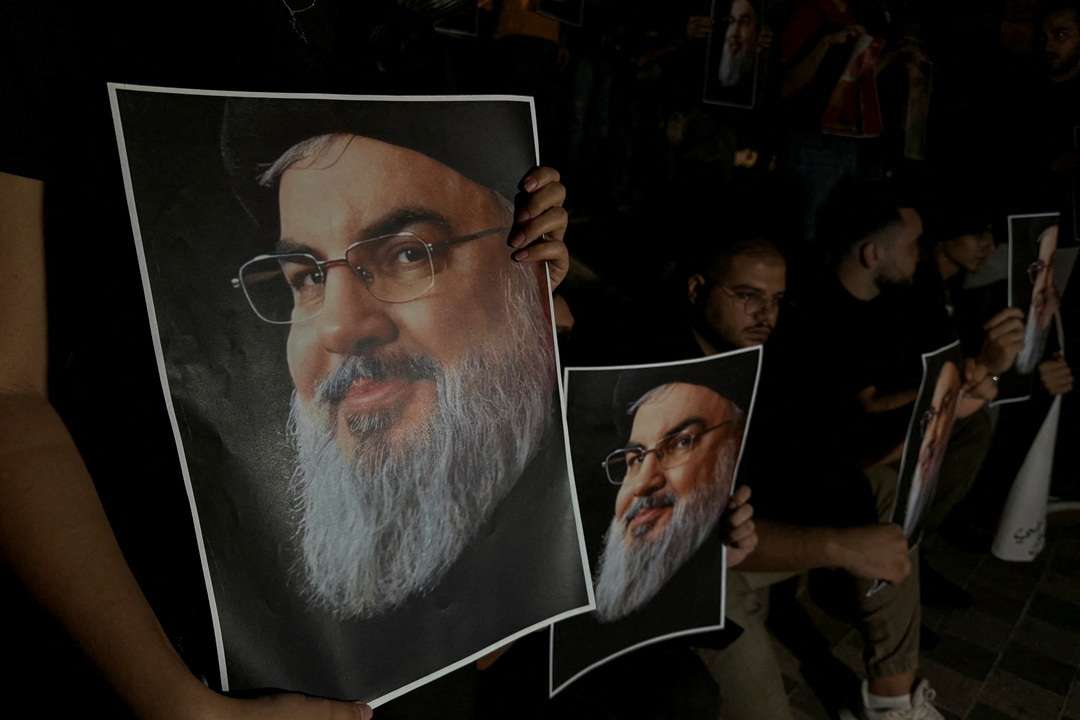 Supporters of Lebanon's Hezbollah leader Sayyed Hassan Nasrallah carry his pictures as they gather in Sidon
