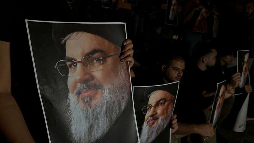 Supporters of Lebanon's Hezbollah leader Sayyed Hassan Nasrallah carry his pictures as they gather in Sidon