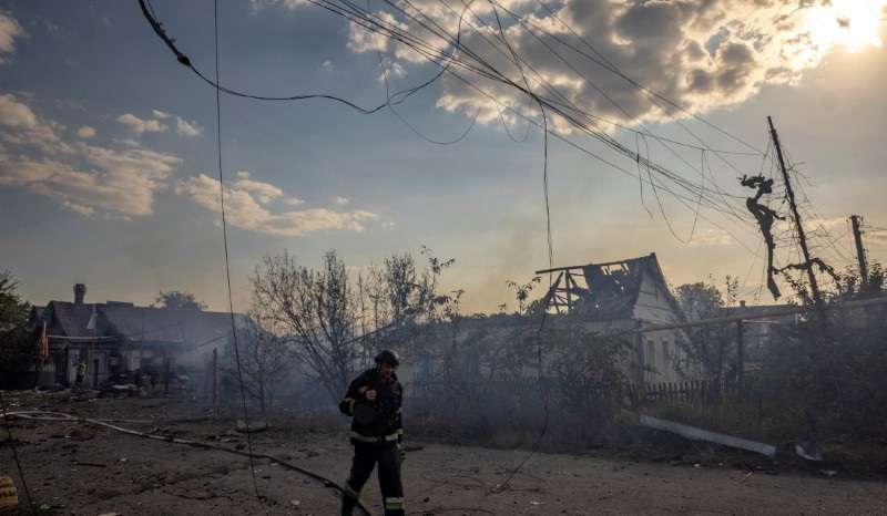 An emergency worker walks past a house that was destroyed after a Russian strike on a residential area in Pokrovsk