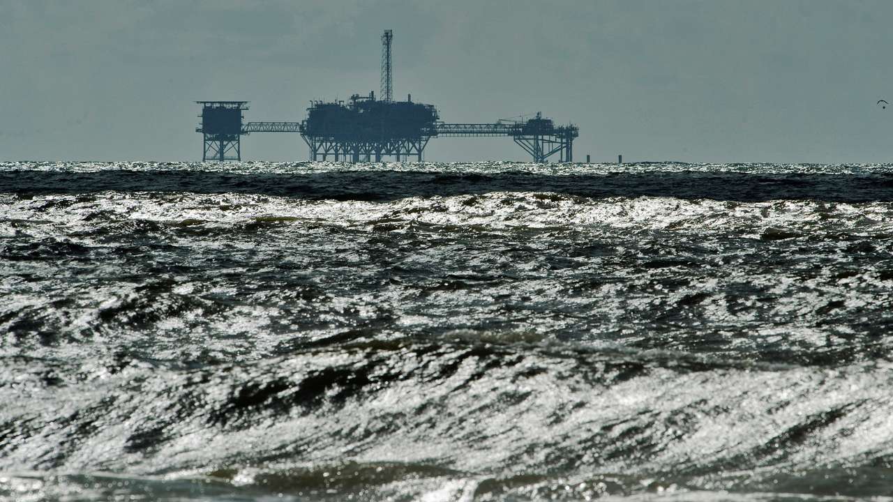 FILE PHOTO: An oil and gas drilling platform stands offshore near Dauphin Island, Alabama
