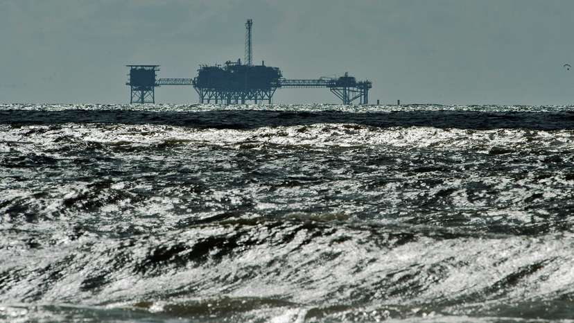 FILE PHOTO: An oil and gas drilling platform stands offshore near Dauphin Island, Alabama