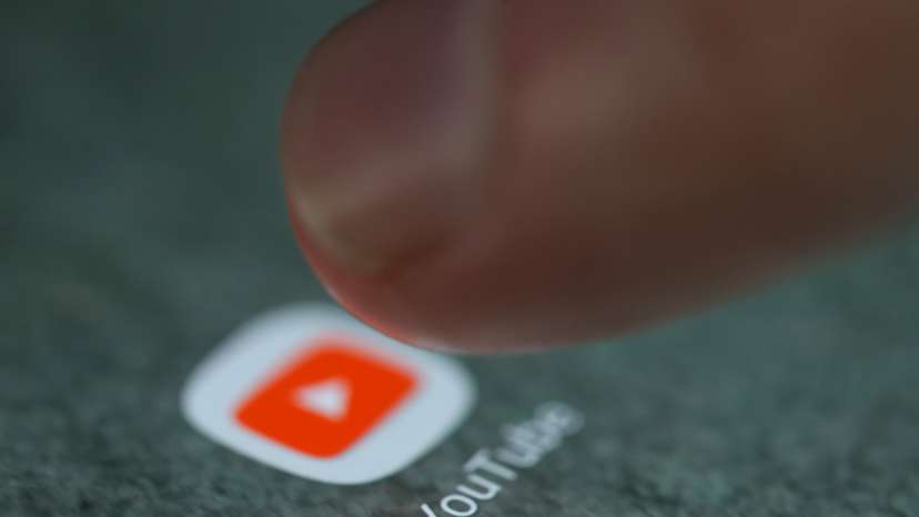 The YouTube app logo is seen on a smartphone in this illustration
