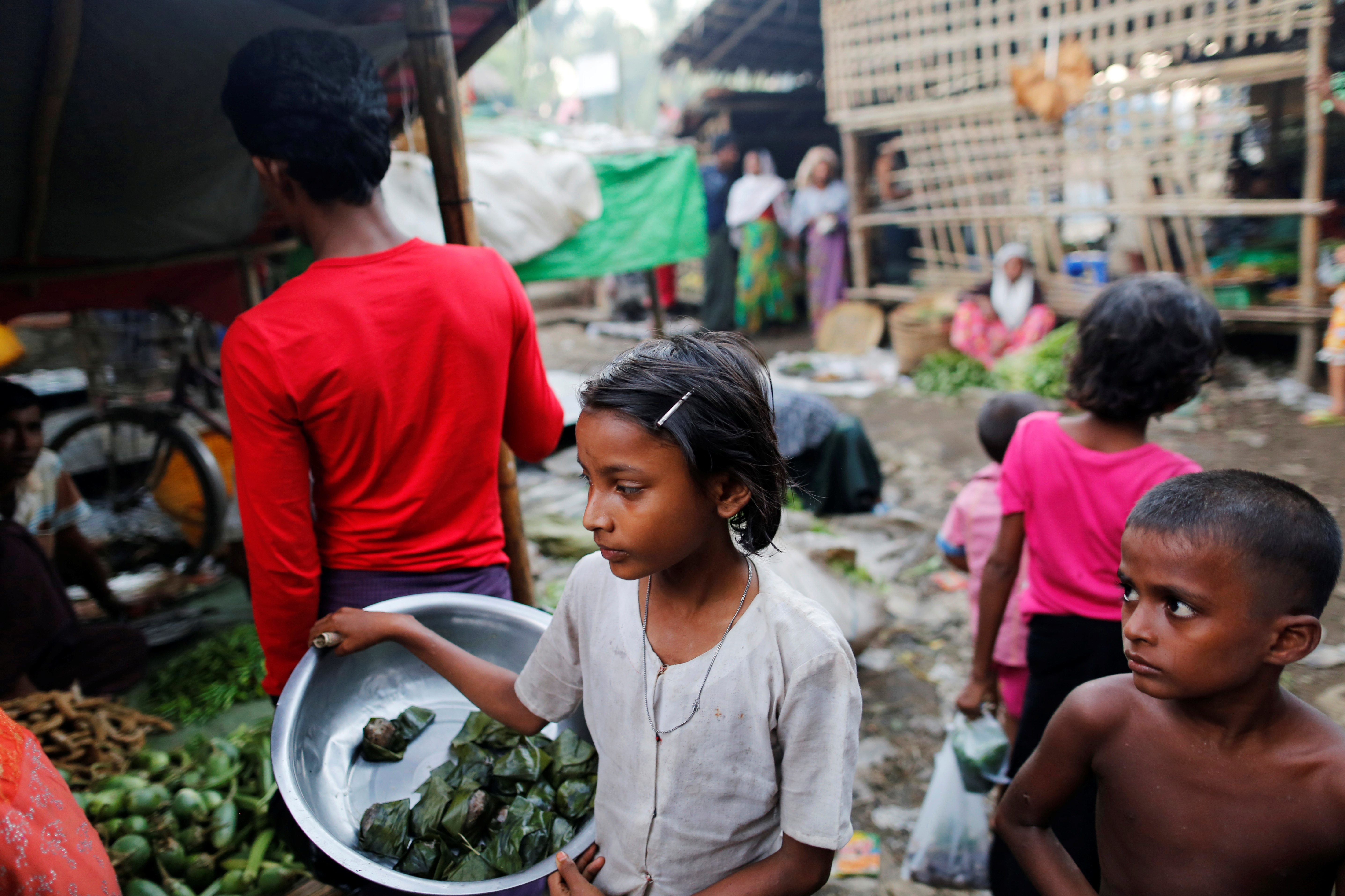 A girls sells food at the internally displaced persons camp for Rohingya people outside Sittwe in the state of Rakhine