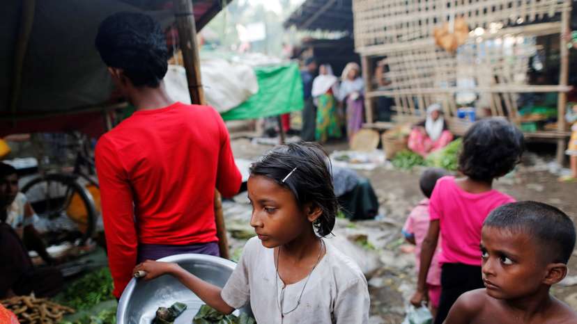A girls sells food at the internally displaced persons camp for Rohingya people outside Sittwe in the state of Rakhine