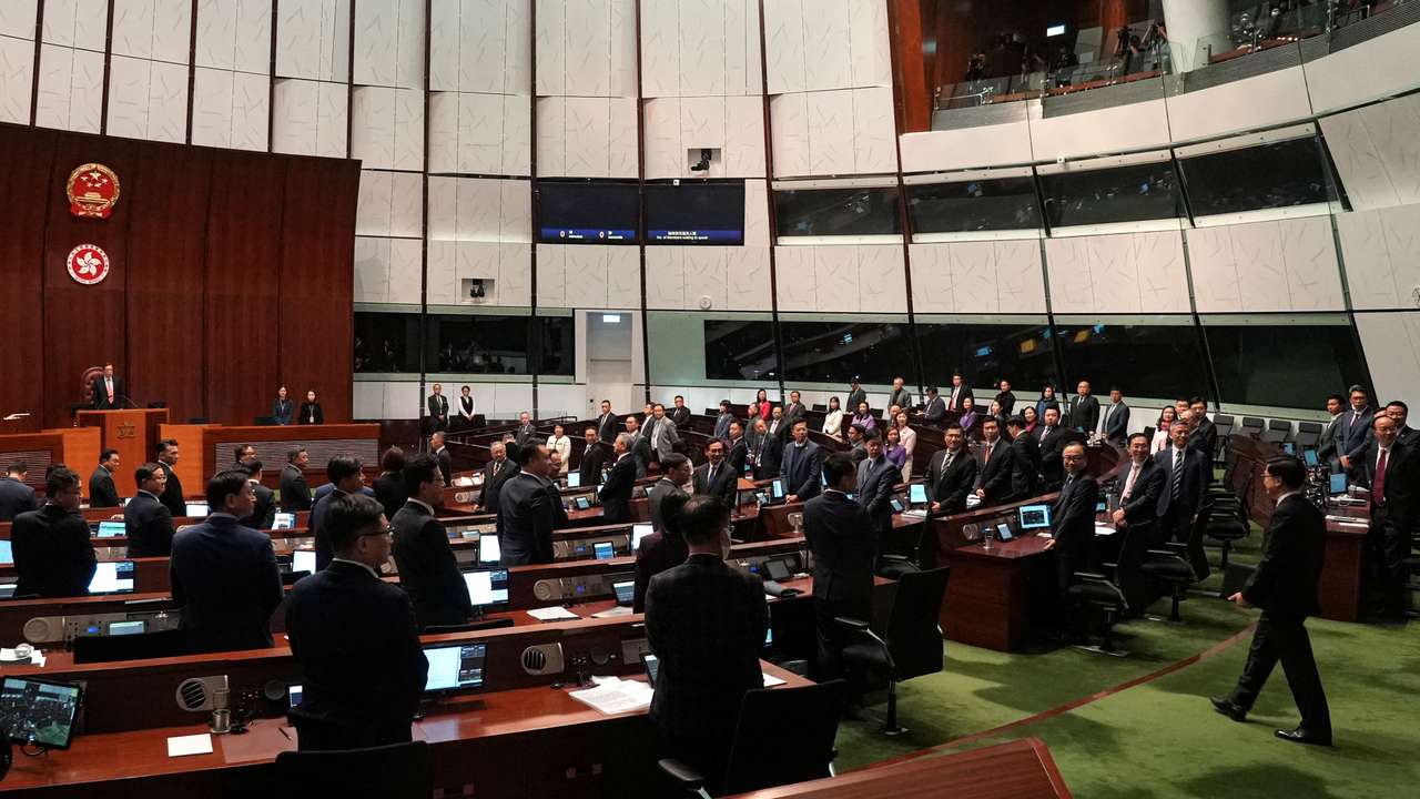 Hong Kong Chief Executive John Lee enters the chamber after the Basic Law Article 23 is passed