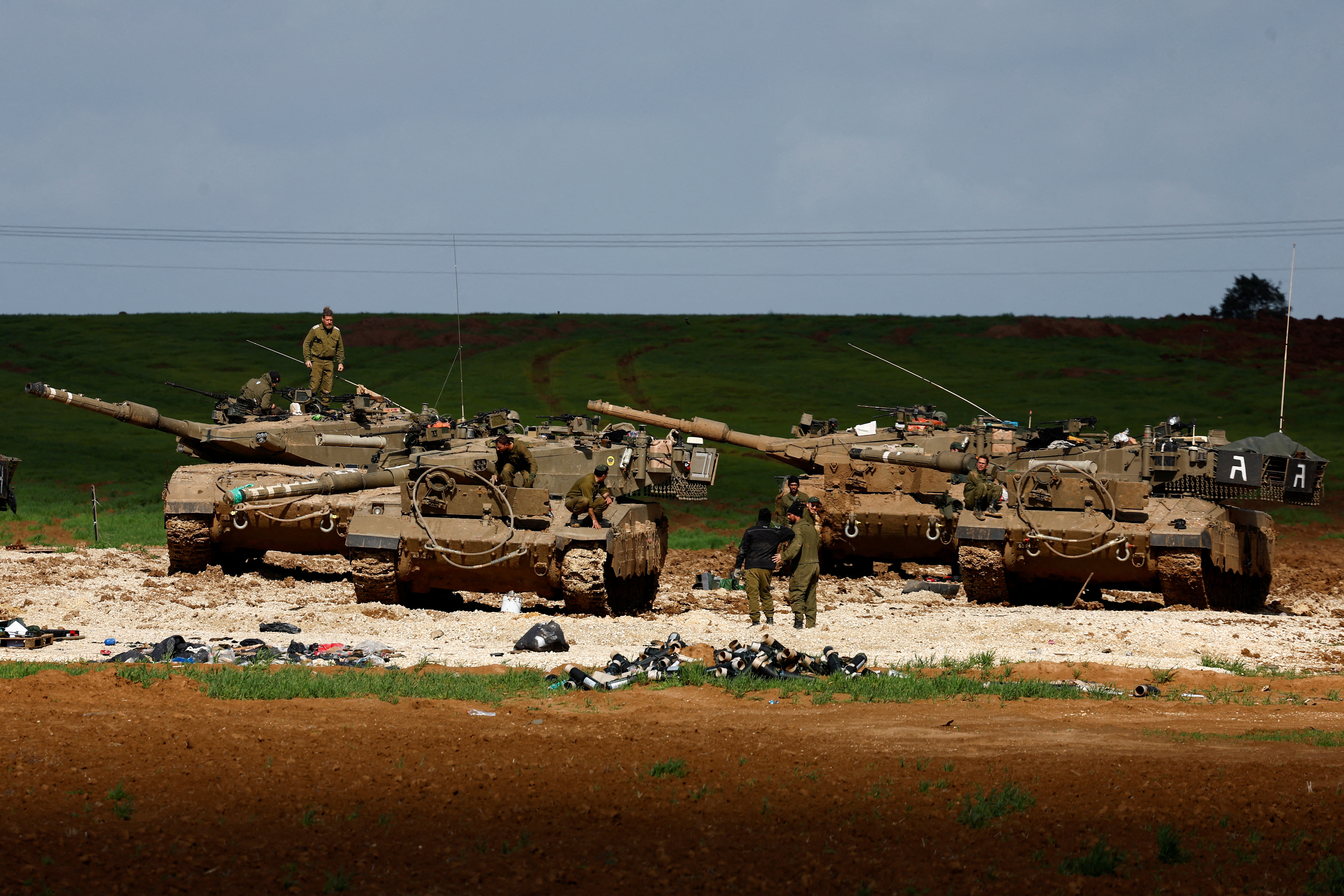 Israeli soldiers work by their tanks near Israel-Gaza border