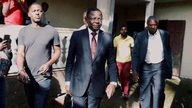 Maurice Kamto, a presidential candidate of Renaissance Movement (MRC), walks with his staff after his news conference at his headquarter in Yaounde