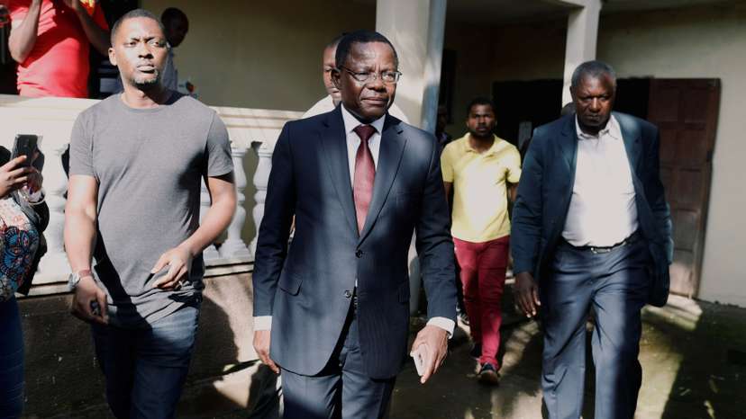 Maurice Kamto, a presidential candidate of Renaissance Movement (MRC), walks with his staff after his news conference at his headquarter in Yaounde