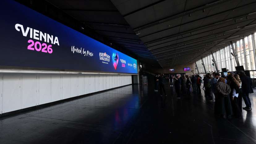 Journalists stand in front of a screen in Wiener Stadthalle, the venue of next year's Eurovision in Vienna