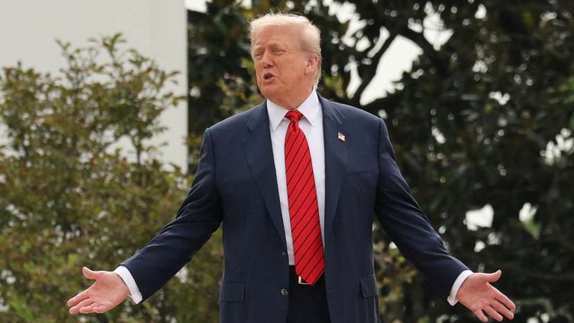U.S. President Trump talks with architect McCrery as they walk on the roof of the White House in Washington