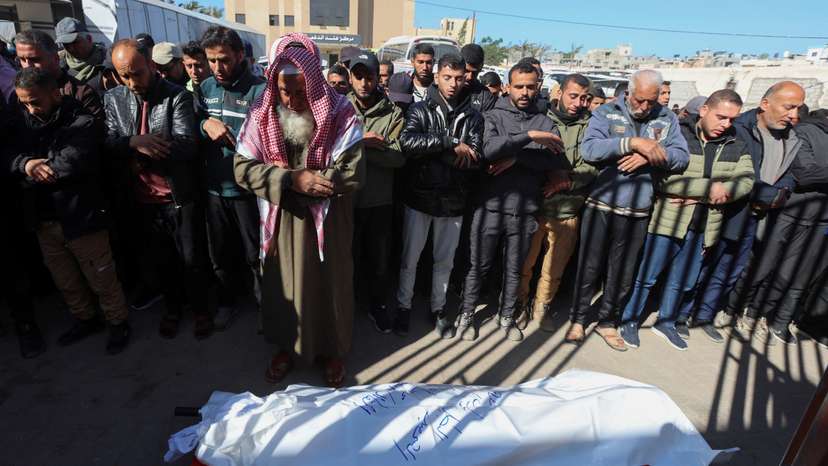 Mourners perform funeral prayers for senior Hamas police officer Mahmoud Al-Astal, who was killed on Monday, at Nasser Hospital in Khan Younis