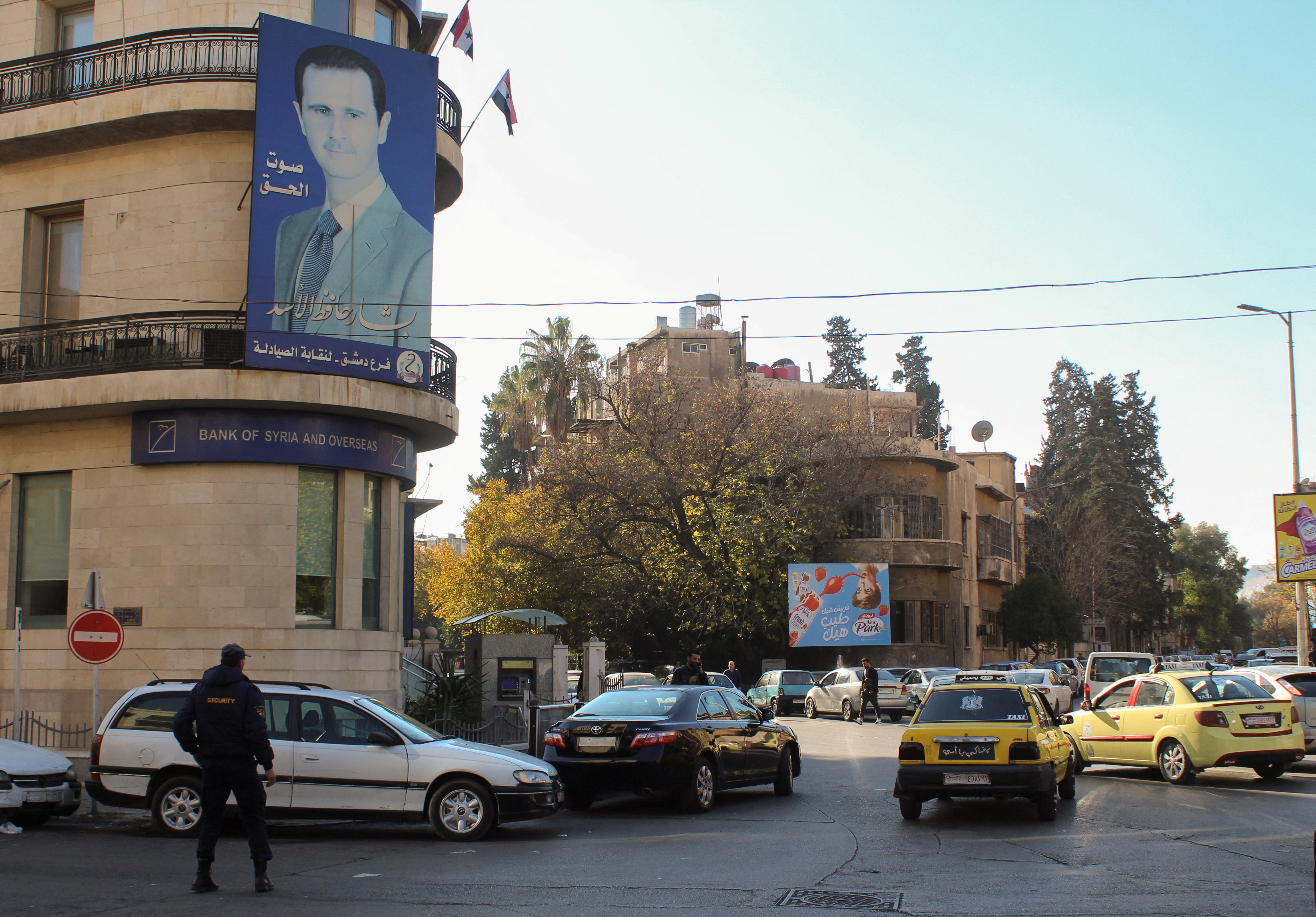 A poster depicting Syria's President Bashar al-Assad is placed on a building in Damascus