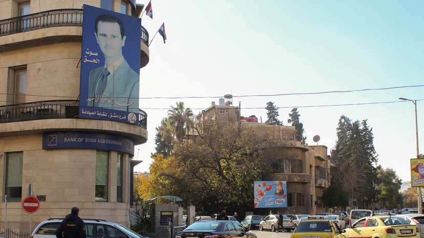 A poster depicting Syria's President Bashar al-Assad is placed on a building in Damascus