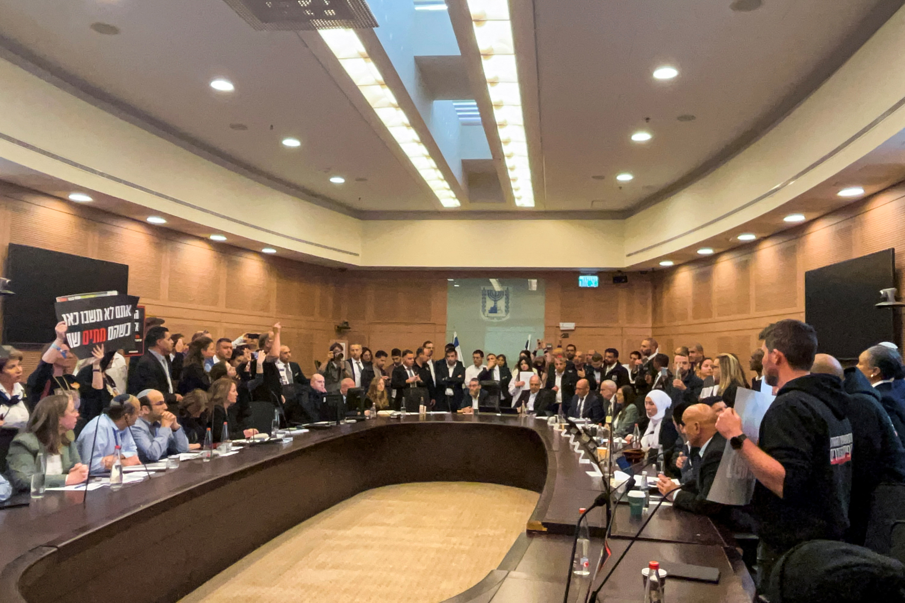 Relatives of Israelis who have been held hostage by Hamas militants since October 7, storm a parliamentary committee session demanding that the lawmakers do more to try to free their loved ones, in Jerusalem