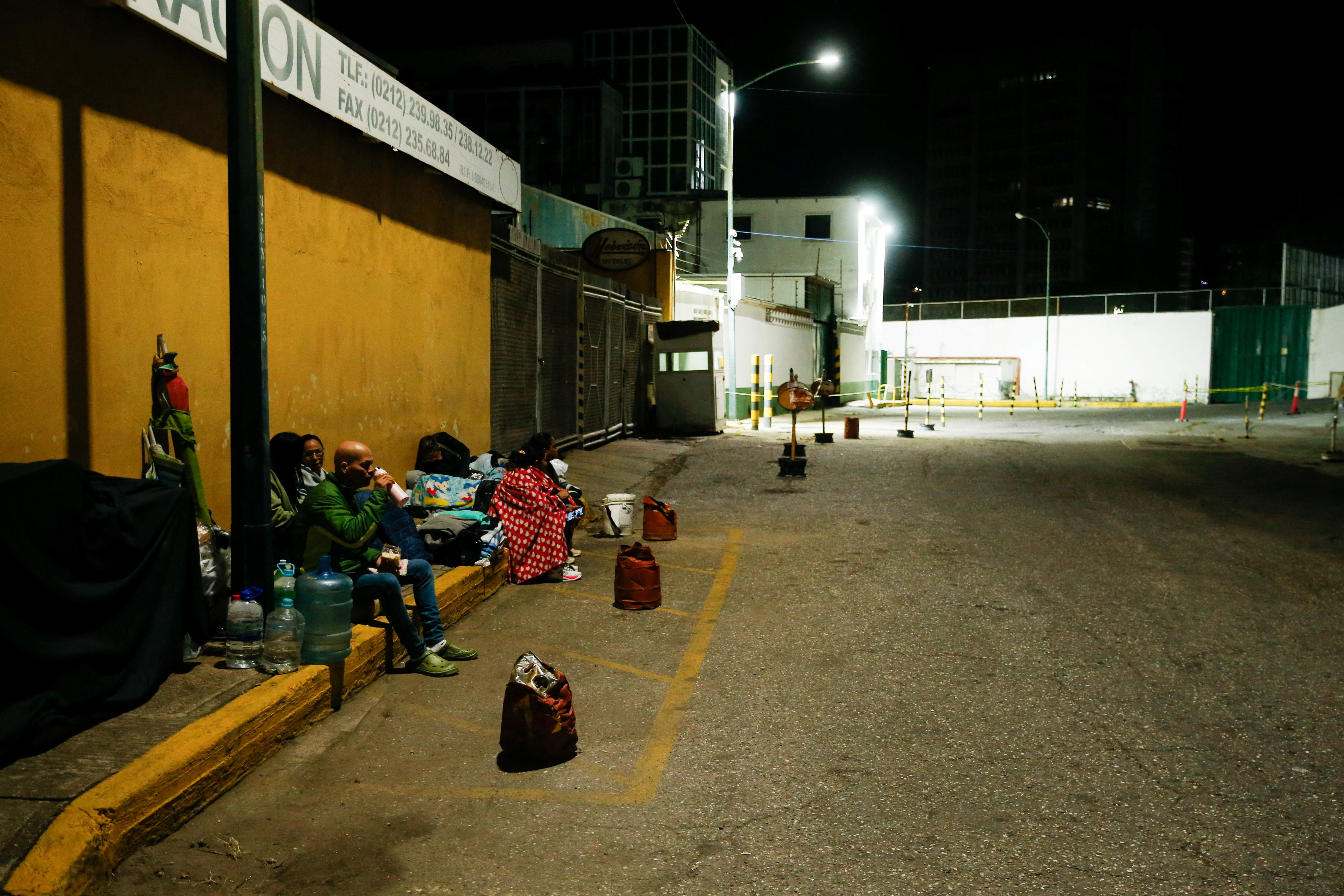 Family members of detainees wait outside the National Police Zone 7 Detention Centre, in Caracas