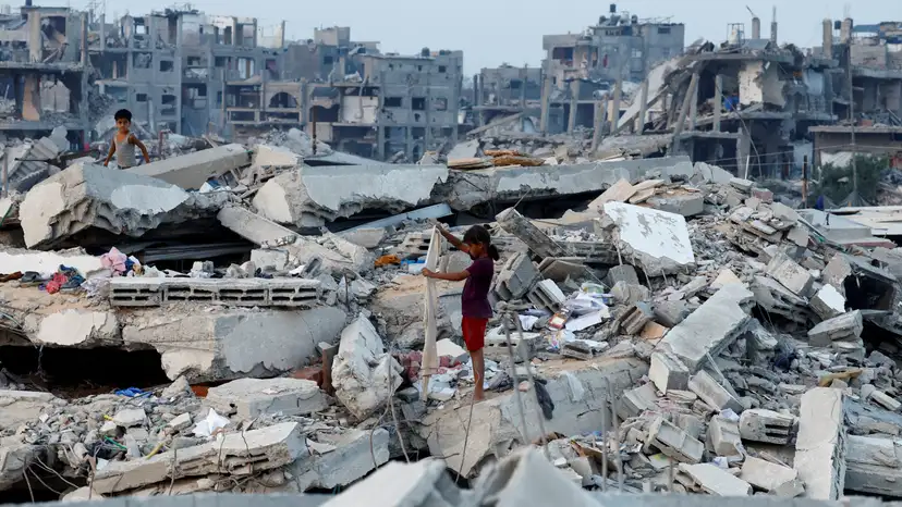 Palestinian children stand on the rubble of destroyed buildings, amid a ceasefire between Israel and Hamas, in Jabalia