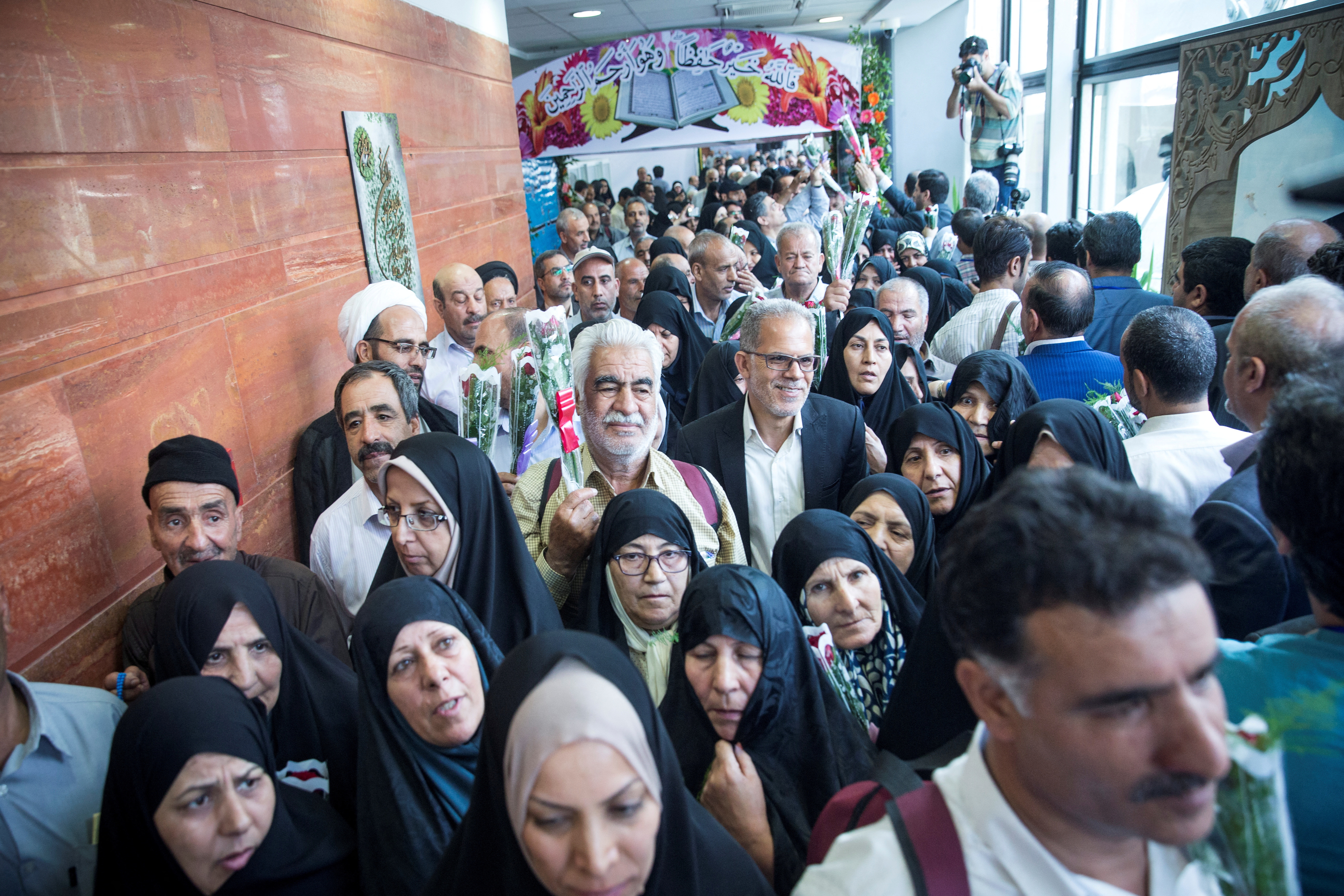 FILE PHOTO: Iranian pilgrims wait at the Imam Khomeini Airport as they depart for the annual haj pilgrimage to the holy city of Mecca, in Tehran