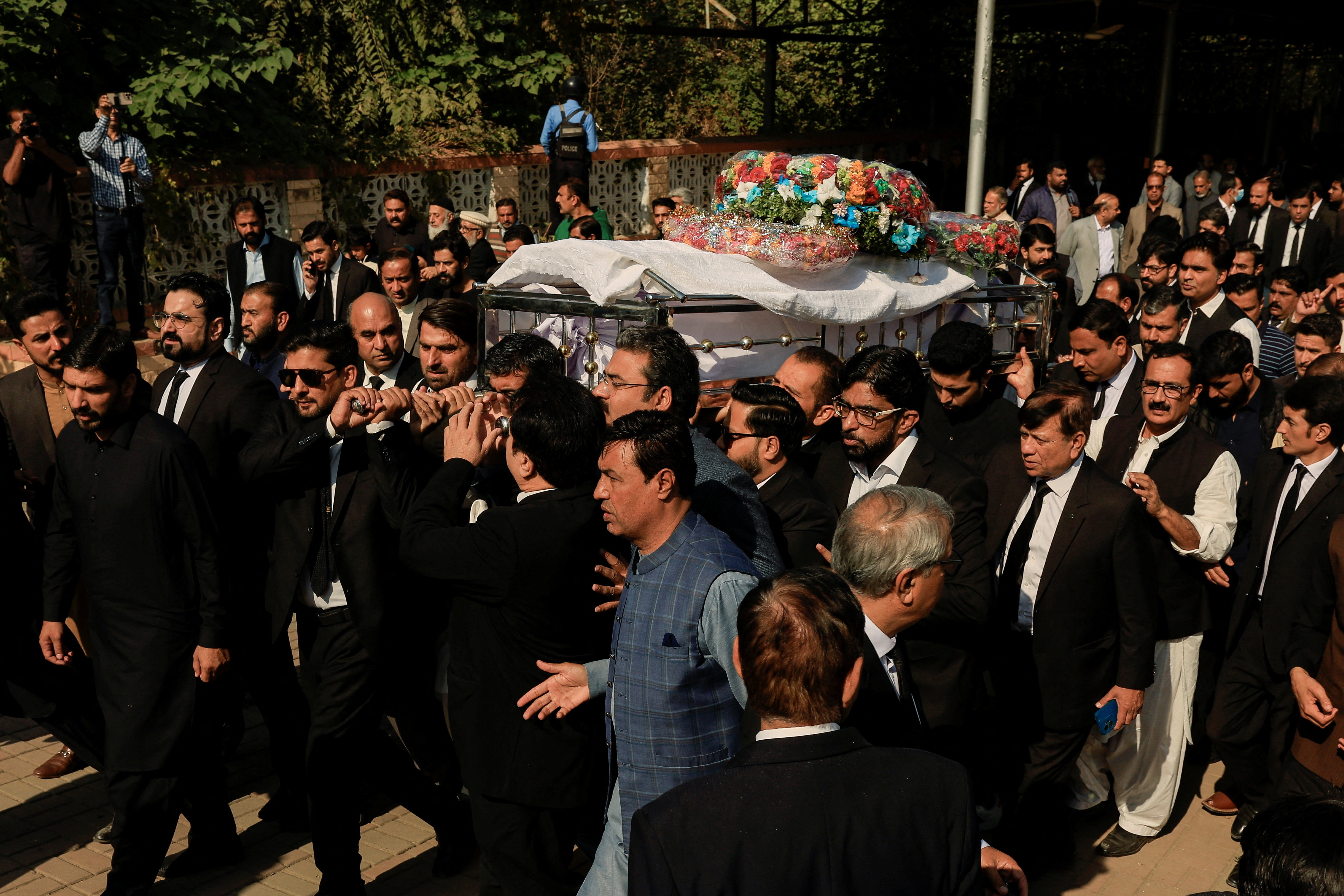 Lawyers carry the coffin of Zubair Aslam Ghuman, a lawyer who was killed yesterday in a blast, outside district court building, as they attend a funeral in Islamabad