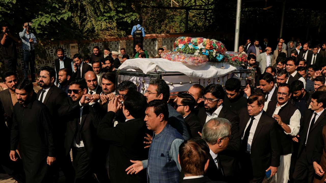 Lawyers carry the coffin of Zubair Aslam Ghuman, a lawyer who was killed yesterday in a blast, outside district court building, as they attend a funeral in Islamabad