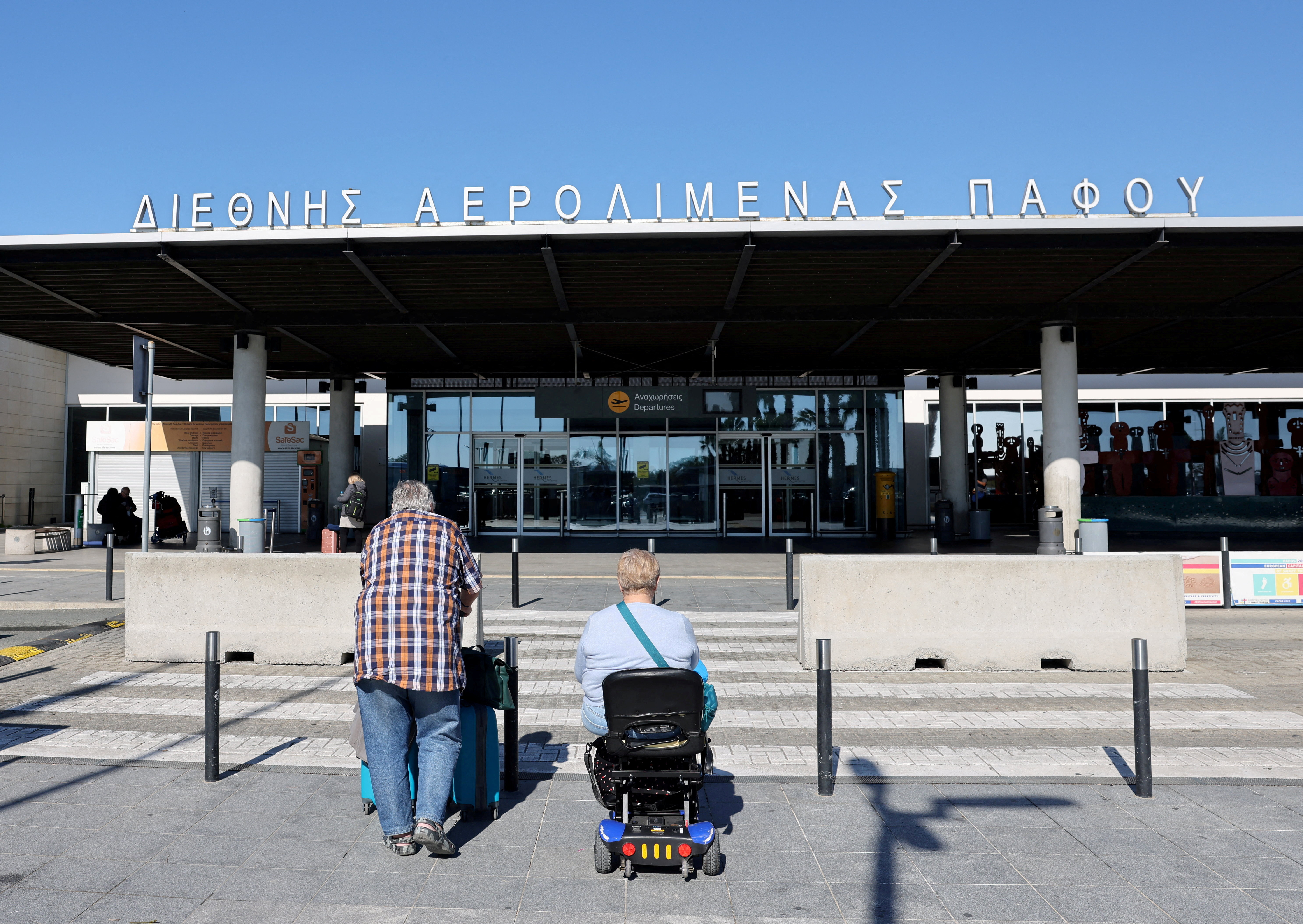 Tourists approach Paphos International Airport with their luggage in Paphos