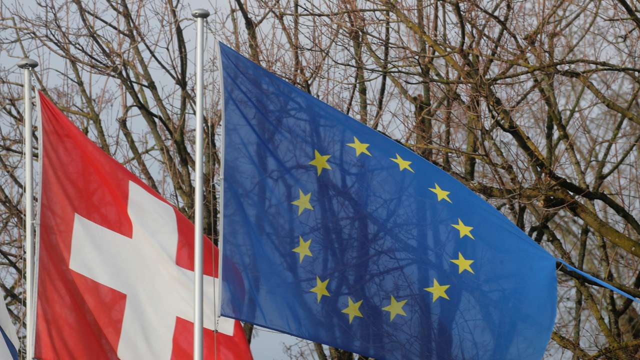 Switzerland's national flag flies beside the one of the European Union in Steinhausen