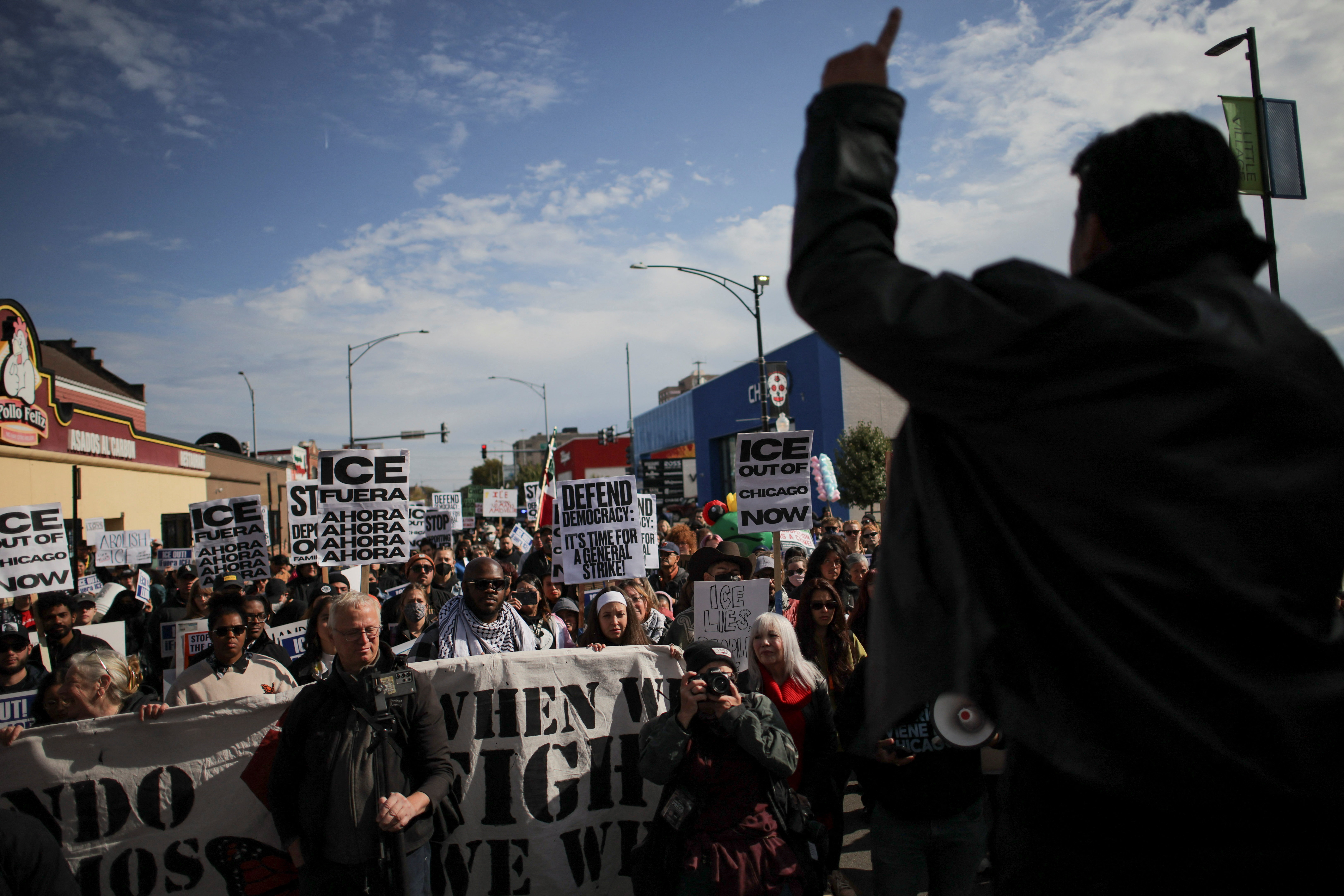 People gather for a protest against ICE raids in Little Village, Chicago