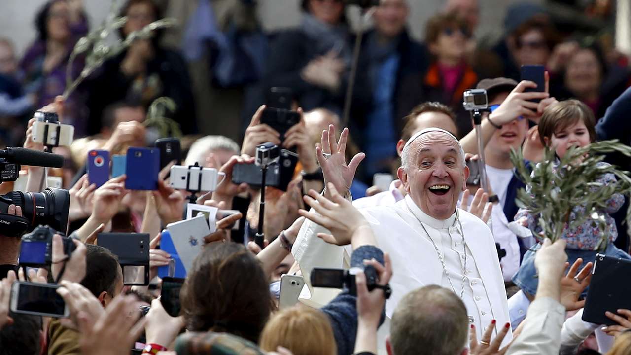 FILE PHOTO: Pope Francis waves at the end of the Palm Sunday mass at Saint Peter's Square at the Vatican