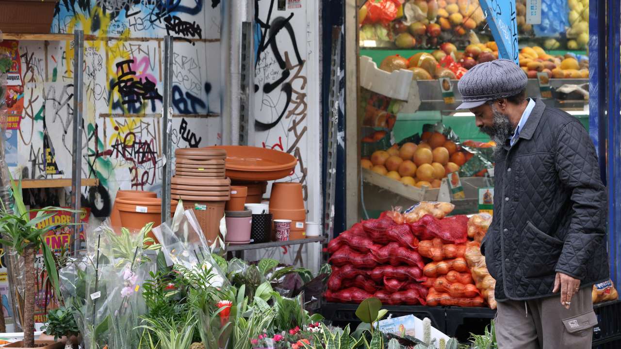 A person shops for fresh products in Peckham, in London