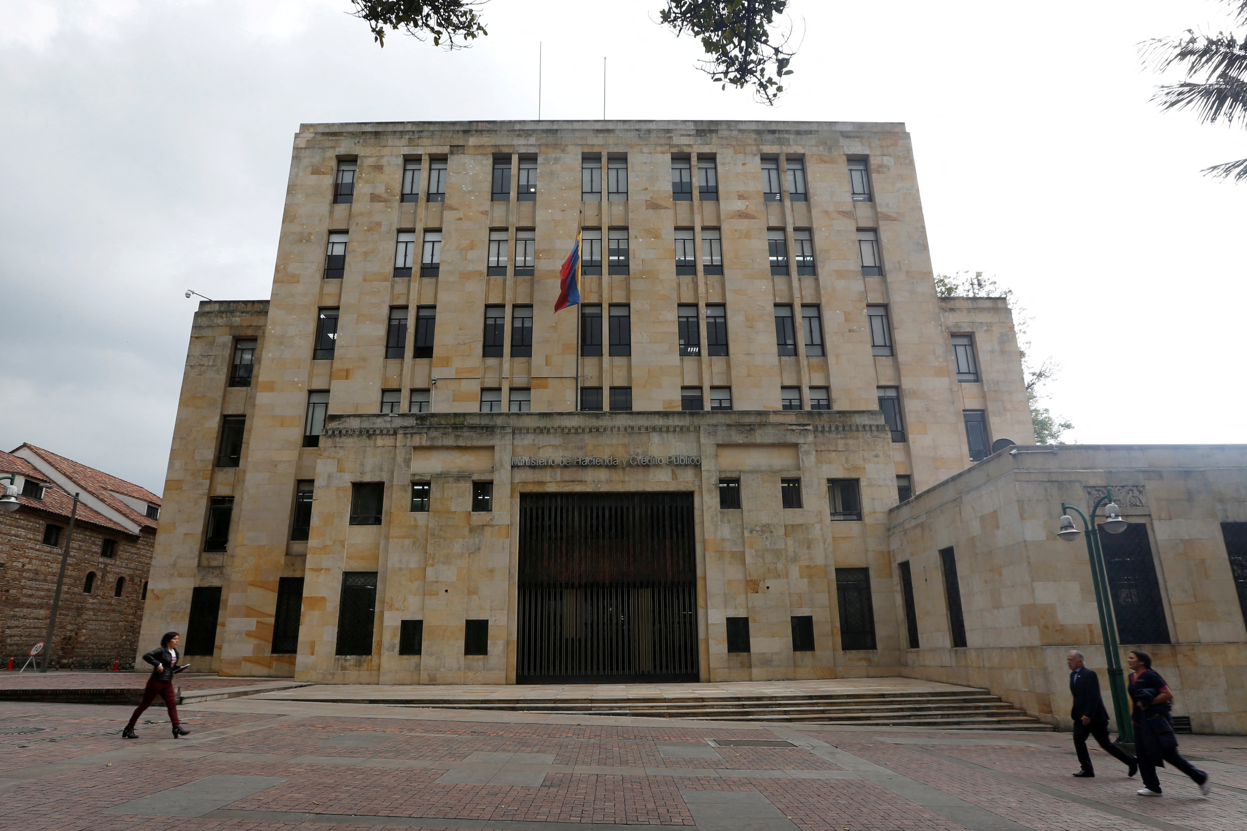 FILE PHOTO: Poeple walk in front of Colombian Ministry of Finance and Public Credit in Bogota