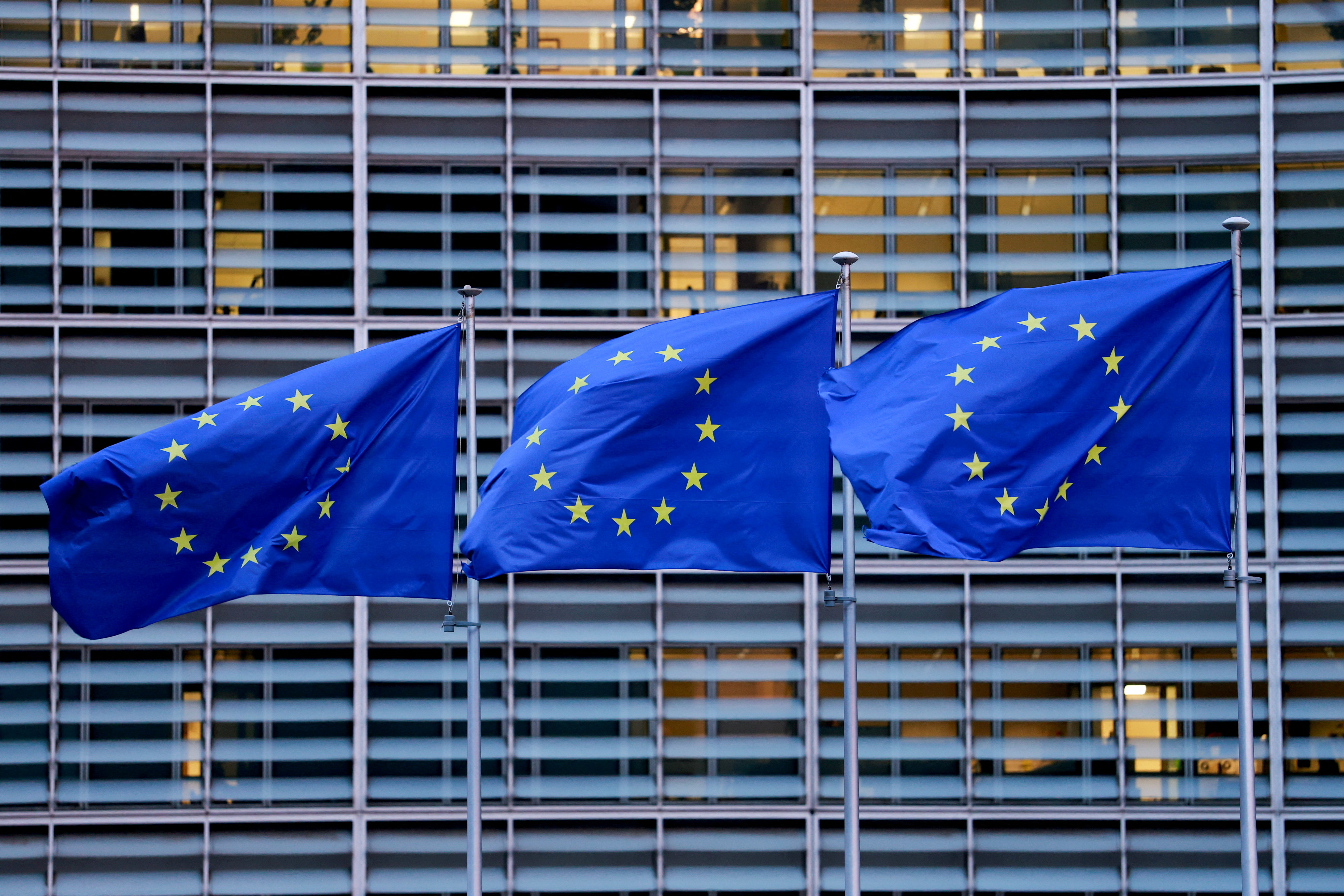 FILE PHOTO: European Union flags flutter outside the European Commission headquarters in Brussels