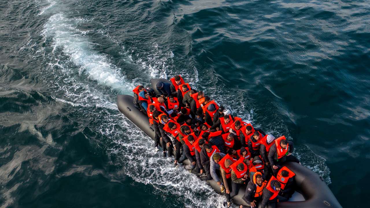 Migrants cross the English Channel in small boats