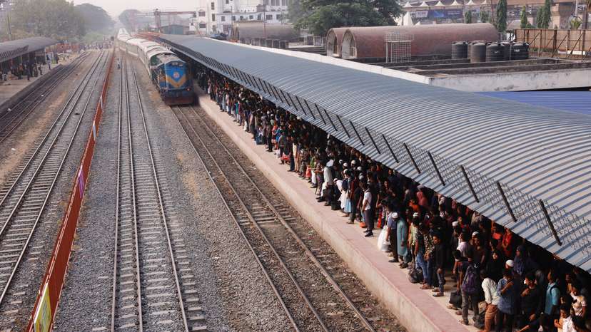 People wait for trains at the Airport Railway Station, to go home ahead of Eid al-fitr, in Dhaka