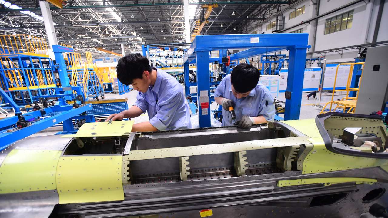 FILE PHOTO: Workers assemble part of the engine assembly for China's self developed C919 passenger aircraft at a factory of Shenyang Aircraft Corporation in Shenyang