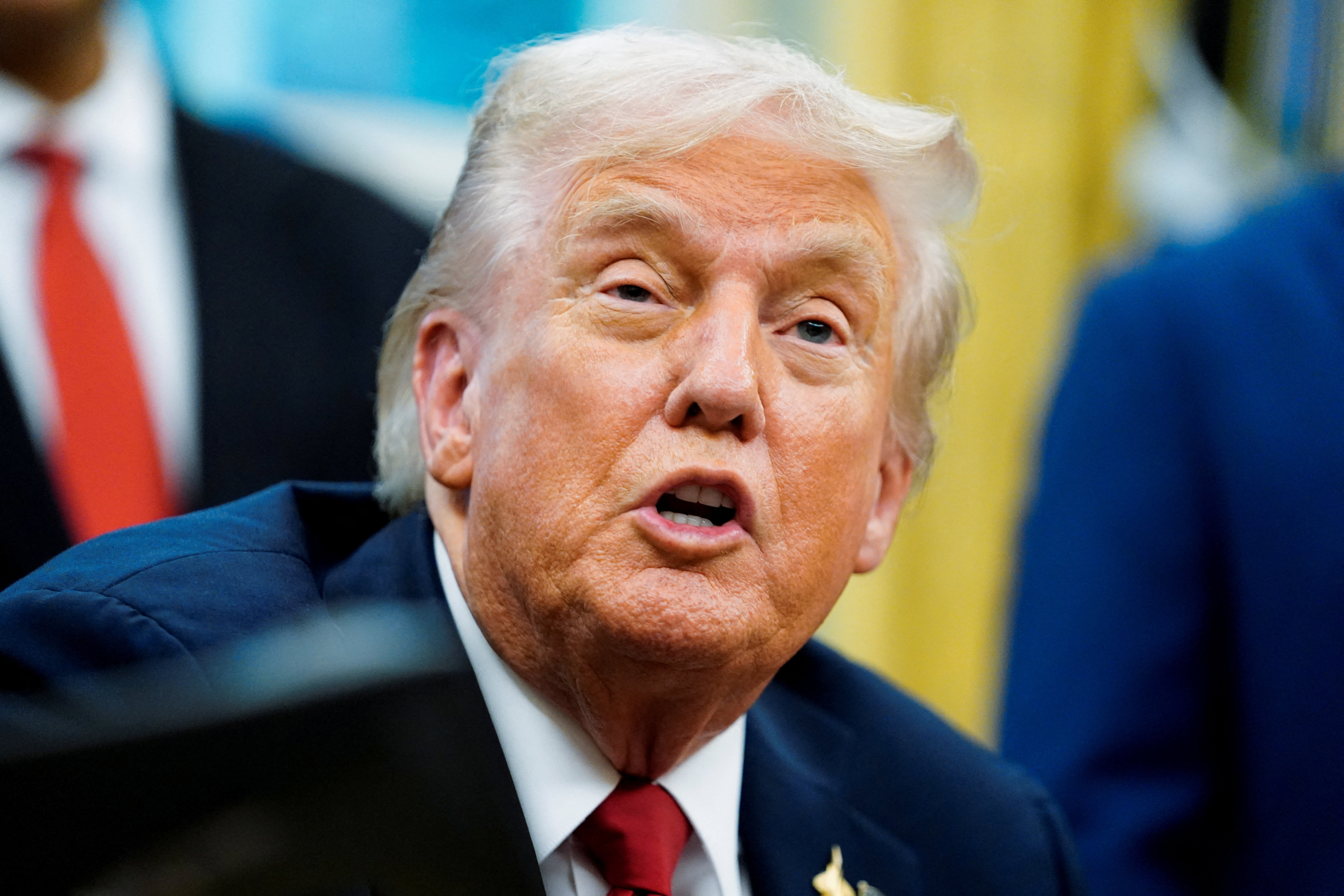 U.S. President Donald Trump signs an executive order in the Oval Office of the White House
