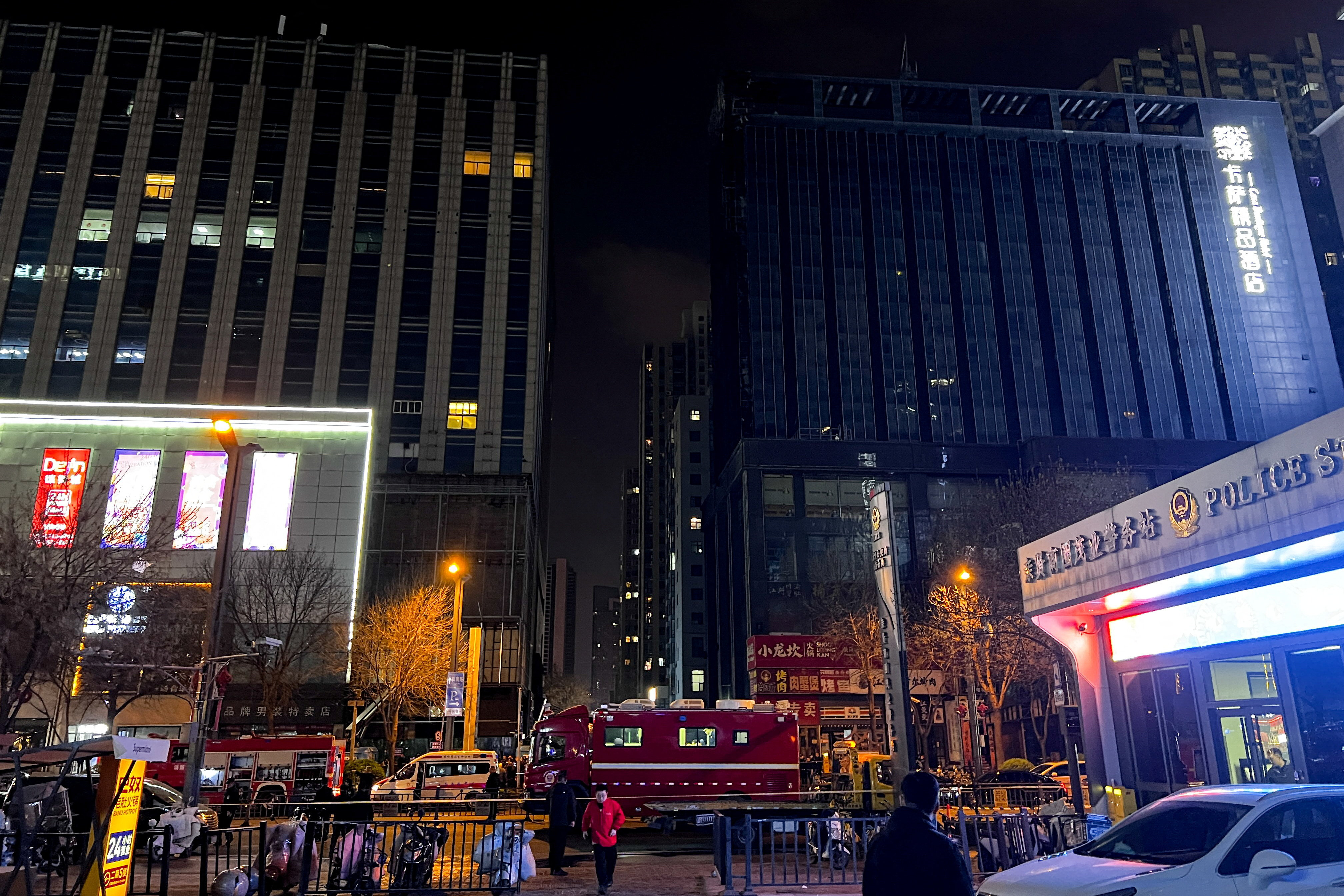 Ambulances and fire trucks stand outside a building after a fire broke out, in Taiyuan, Shanxi
