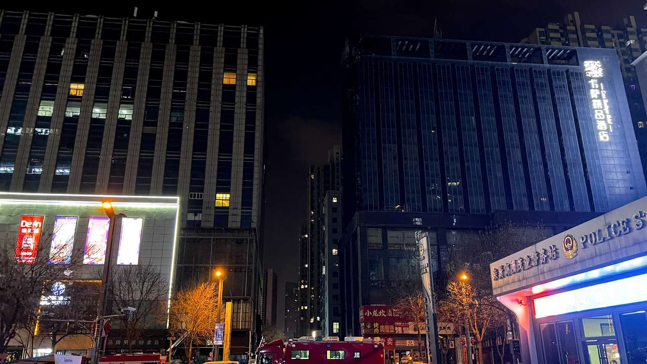 Ambulances and fire trucks stand outside a building after a fire broke out, in Taiyuan, Shanxi