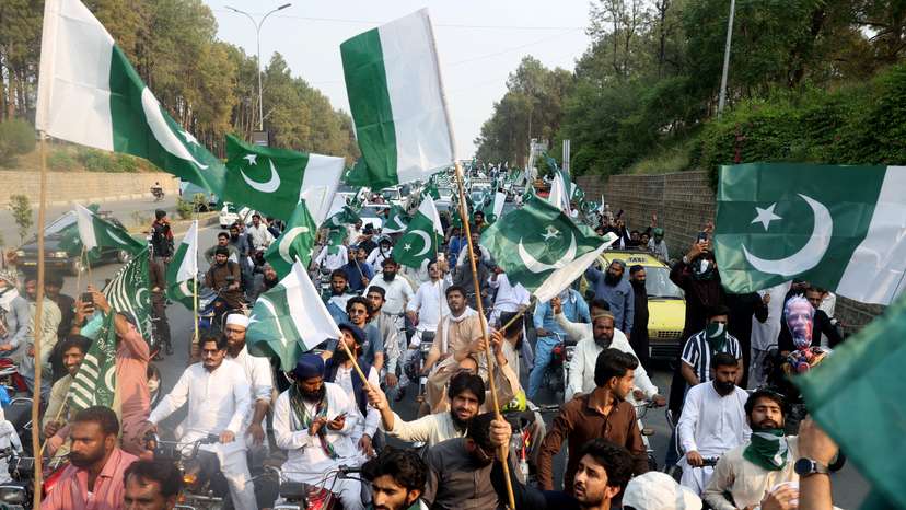 Supporters of Pakistan Markazi Muslim League wave flags during a rally in support of Pakistani Army following India's military strikes on Pakistan, in Islamabad