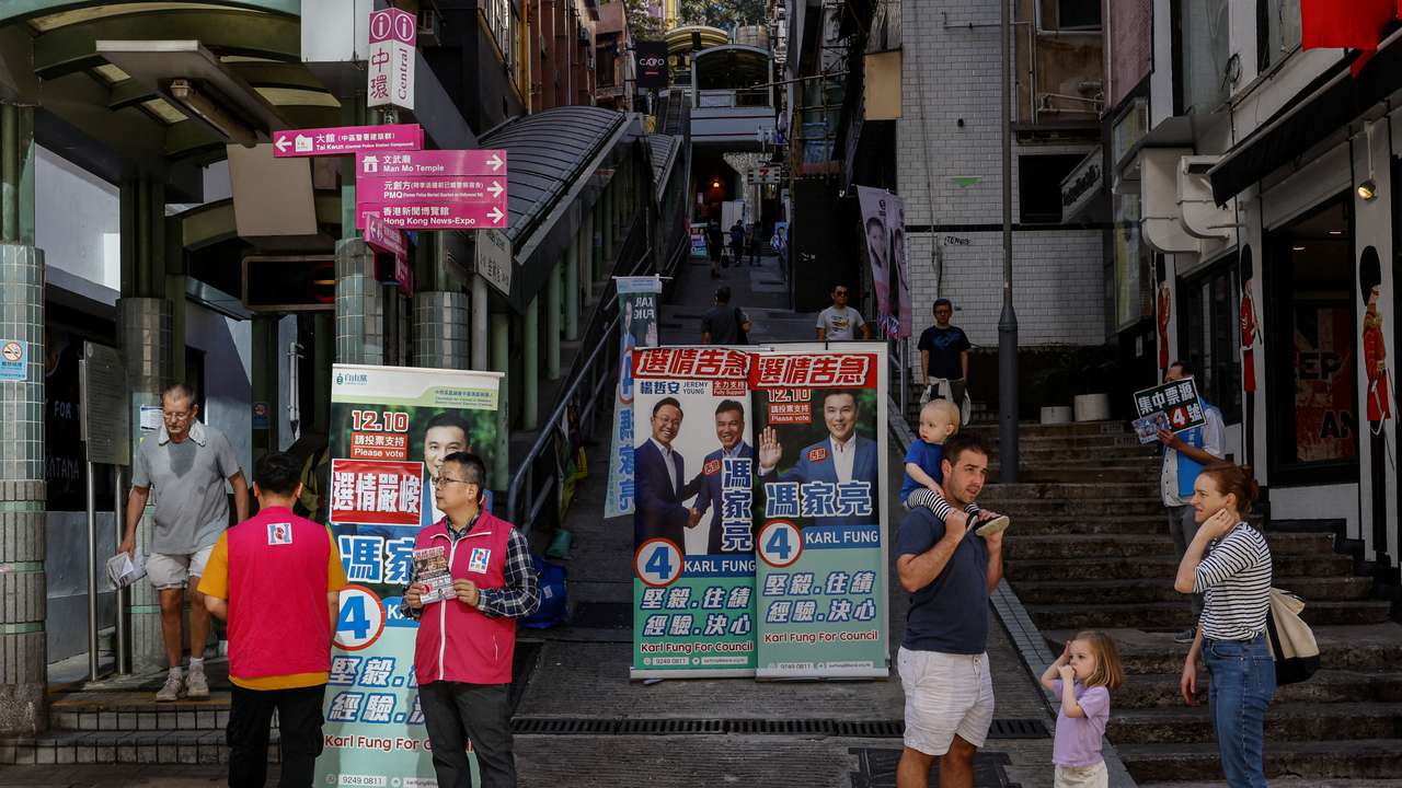 Volunteers campaign for their party during the District Council election in Hong Kong
